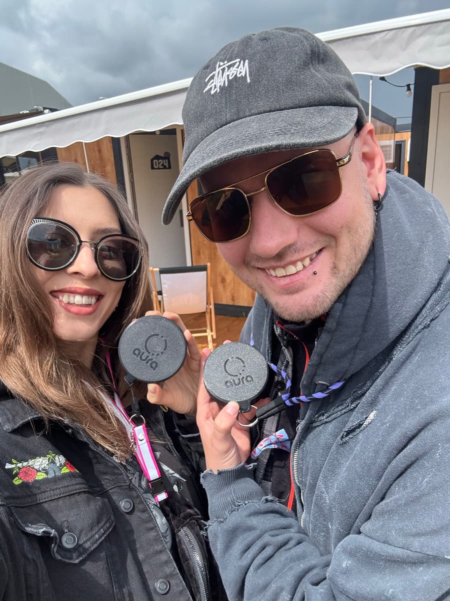 natália and andrej at a festival, holding two aura devices