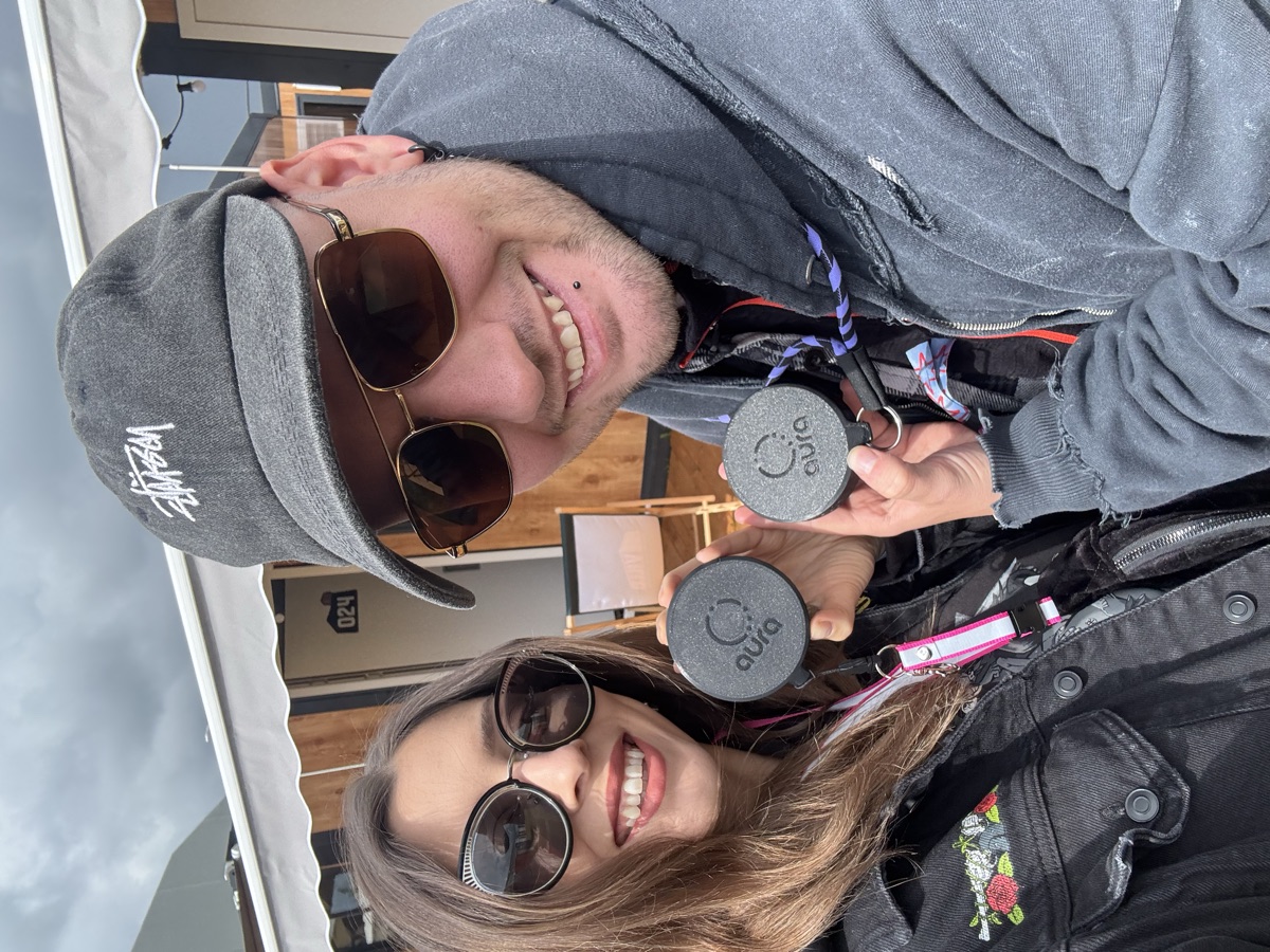 natália and andrej at a festival, holding two aura devices